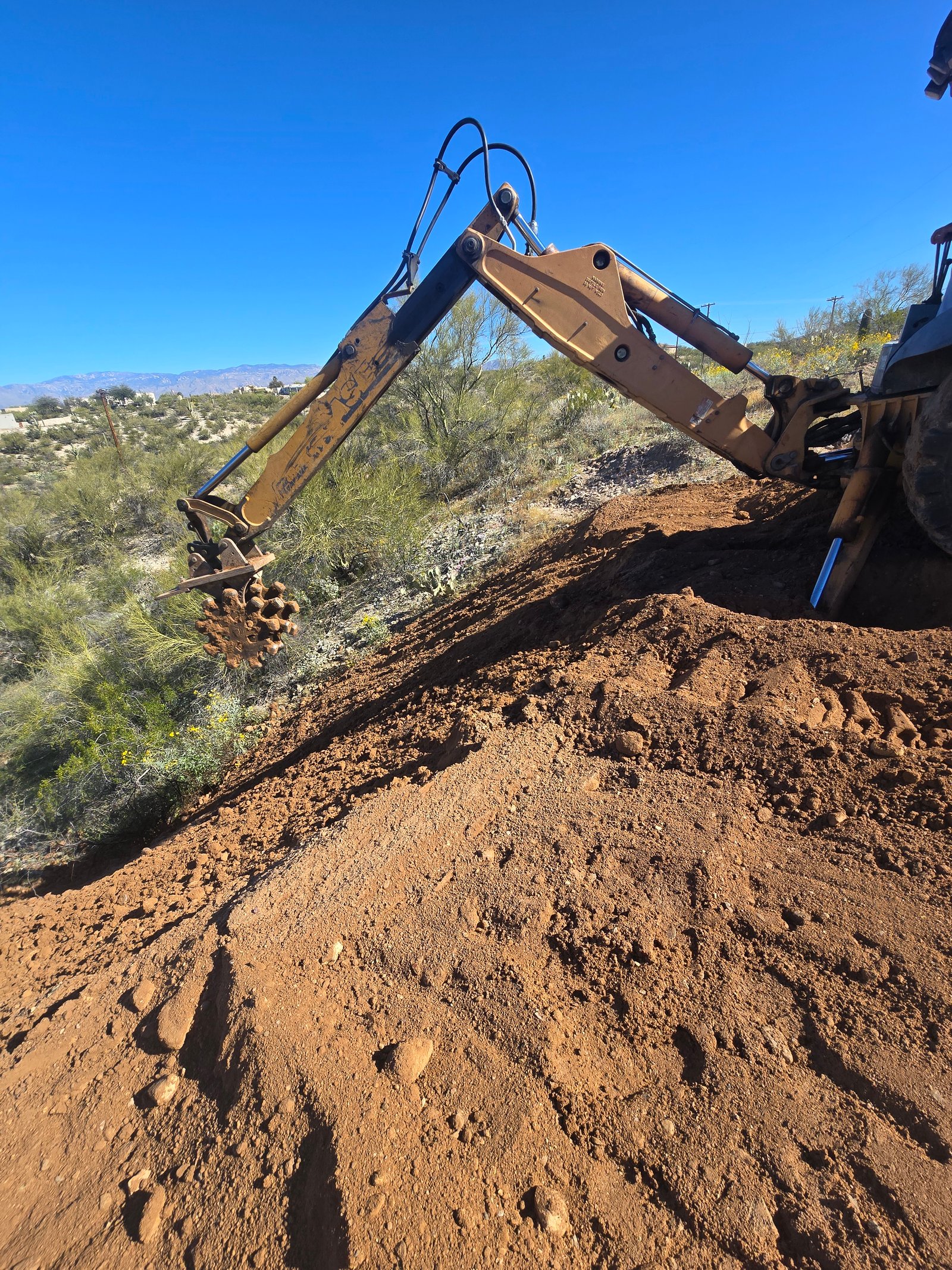 Tamping dirt on a finished slope
